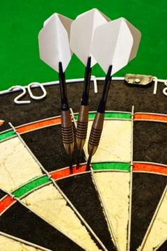 Darts in dartboard Stock Photos