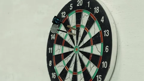 Darts fly exactly at the target of the target hanging on the wall. An atmosphere Stock Footage 318076018
