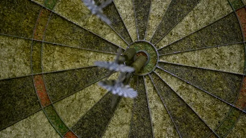 Darts fly into an old dartboard Video stock 172148024