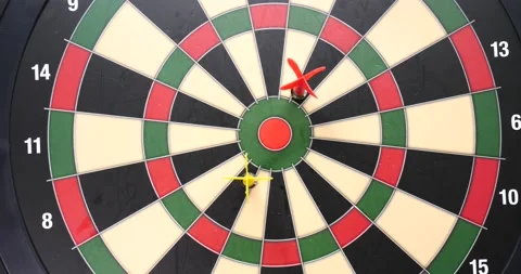 Darts landing on the inner circle of dark board that's magnetic close up Stock Footage 205429975