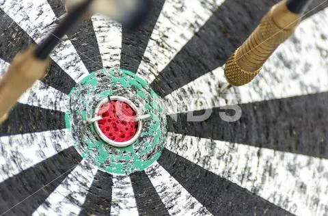 Darts Missing Bullseye on a Worn Out Dartboard. Proper Targeting, Losing Conc Stock Photos