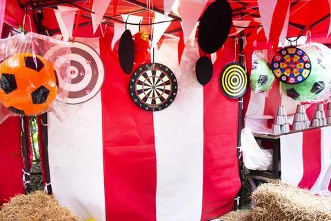 Darts throwing or throwers arrows in dartboard local carnival funfair festi.. Stock Photos