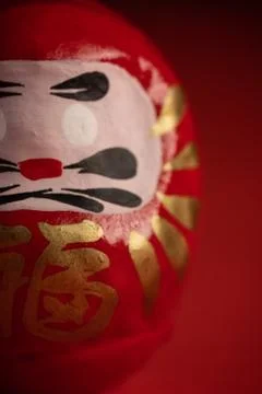 Daruma doll on red background Stock Photos