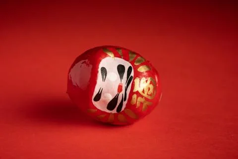 Daruma doll on red background Stock Photos