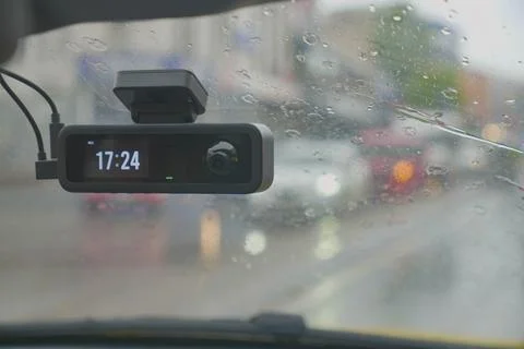 Dash Camera on Windshield in Rainy Traffic With Digital Time Display for Driving Stock Photos
