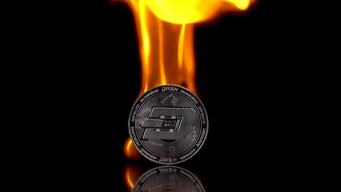 Dash coin catches fire on an isolated black background. Slow motion 250fps. Stock Footage 154007265