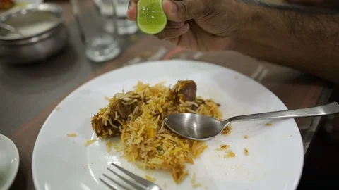 Dash-of-lime-on-mutton-biryani Stock Footage 86794799