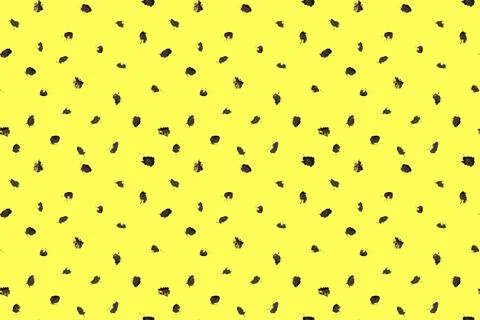 Dash pattern on yellow background. Wrapping paper with small black dots painted Illustrazione stock