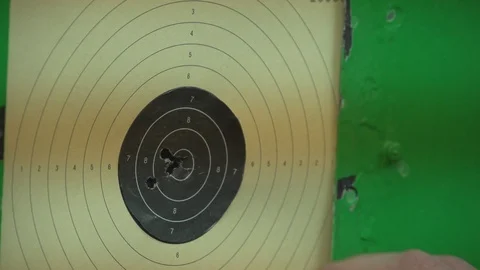 Dash target. Young man calculating a result after shooting. Close up Stock Footage 106121204