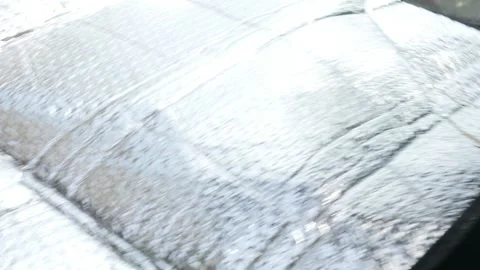 Dashboard and windshield reflective sun protection placing slow-mo video Video stock 95894998