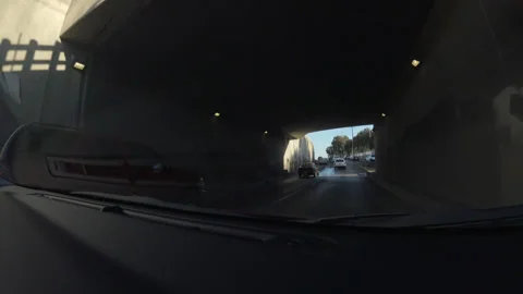 Dashboard Camera View of Driving Through Underpass and Along Highway Stock Footage 344612572
