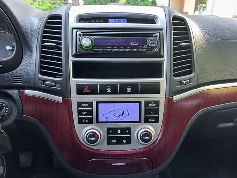 The dashboard features a modern audio system, digital clock, and climate cont Stock Photos