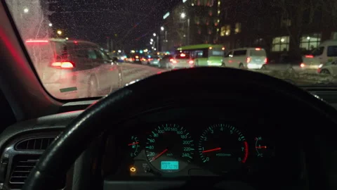 Dashboard lights and congested traffic with icy conditions create tense driving Stock Footage 328378357