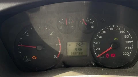 Dashboard lights glow. Engine warning and speed indicators illuminated clearly Stockbeeldmateriaal 347333780