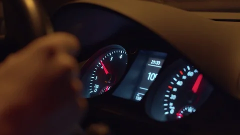 Dashboard lights up inside moving car Stock Footage 128699593