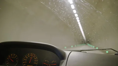 Dashboard Panel in Focus as Vehicle Moves Through a Lit Tunnel Stockbeeldmateriaal 302219472