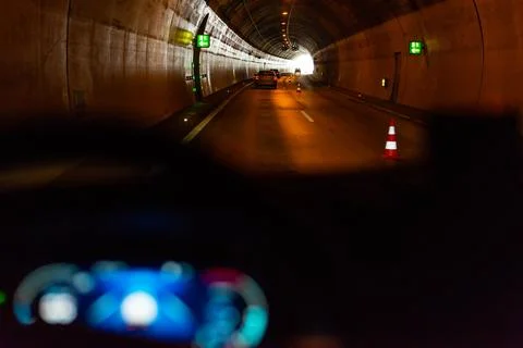 Dashboard view of car driving through dark tunnel at night Stock Photos