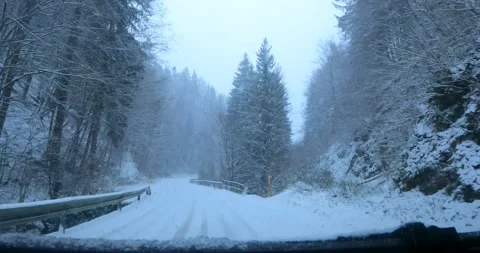 Dashcam car dash camera view of driving on snowy and icy countryside road Stock Footage 144454257