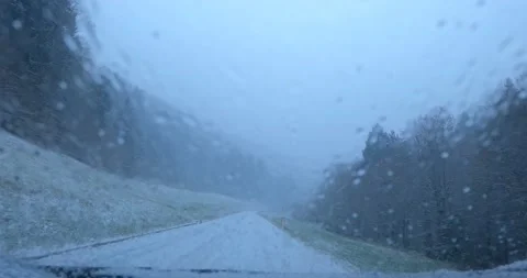 Dashcam car dash camera view of driving on snowy road in Slovenia Stock Footage 144454636