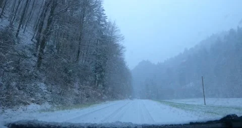 Dashcam car dash camera view of driving on snowy and icy countryside road Stock Footage 144454732