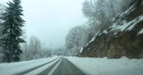 Dashcam dashboard camera POV point of view driving on snowy countryside road Stock Footage 146509375