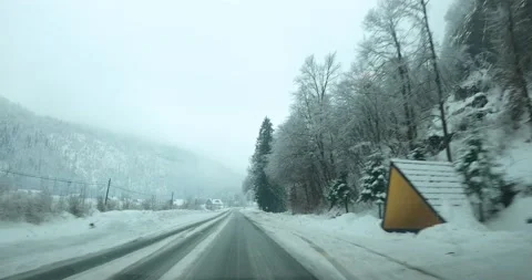 Dashcam dashboard camera POV point of view driving on snowy countryside road Stock Footage 146509431