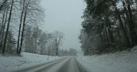 Dashcam POV point of view driving on snowy countryside road in Slovenia Stock Footage 147540564
