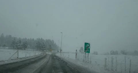 Dashcam POV point of view driving on snowy countryside road in Slovenia Stock Footage 147684971