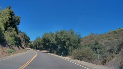 Dashcam view of a residential street on an empty road, Los Angeles Stock Footage 343475488
