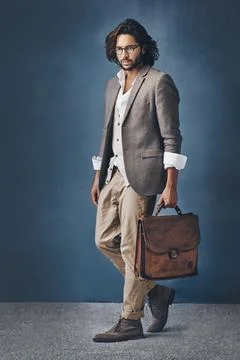 Dashing from head to toe. Studio shot of a handsome young man posing against a Stock Photos