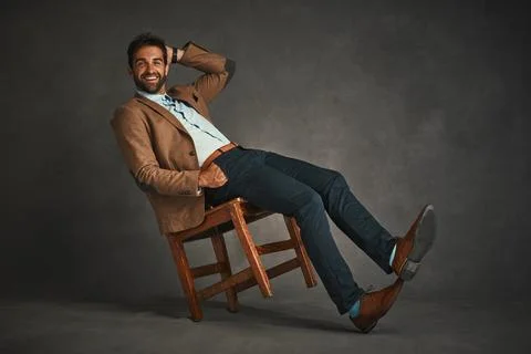 Dashingly handsome. Studio shot of a handsome young man posing against a gray Stock Photos