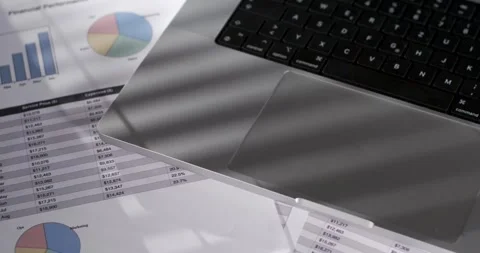 Data analysis with charts and financial documents on a workspace Stock Footage 337229413