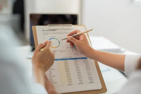 Data Analysis. Close-up of a professional reviewing financial metrics on a Stock Photos