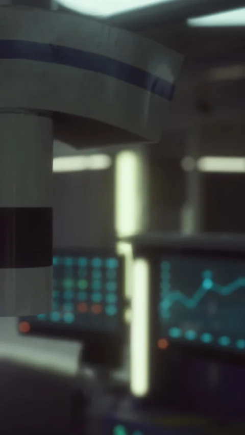 Data analysis in a control room with screens showing graphs and charts Stock Footage 330341028