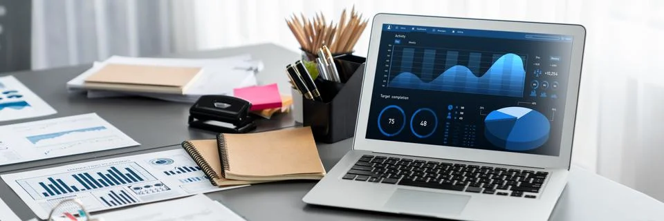 Data analysis dashboard display on laptop screen on office table. Insight Stock Photos