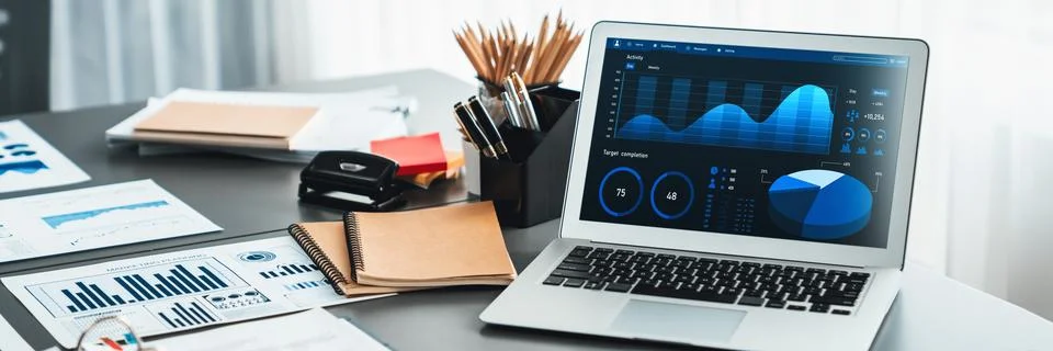 Data analysis dashboard display on laptop screen on office table. Insight Stock Photos