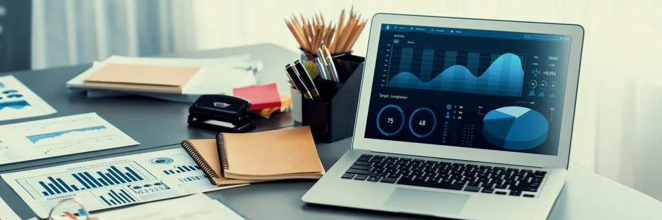 Data analysis dashboard display on laptop screen on office table. Insight Stock Photos