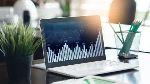 Data analysis on laptop screen with charts and graphs in office environment Stock Photos