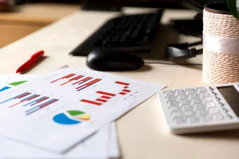 Data analysis - workplace with business graphs and charts, keyboard and calcu Stock Photos