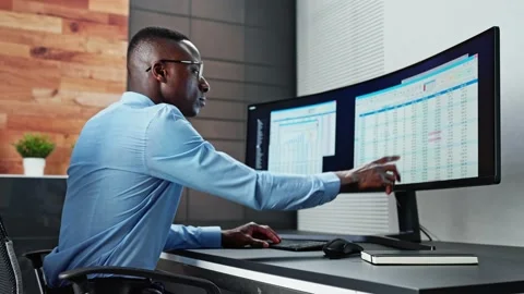 Data Analyst African Man Using Spreadsheet Stock Footage 220897145