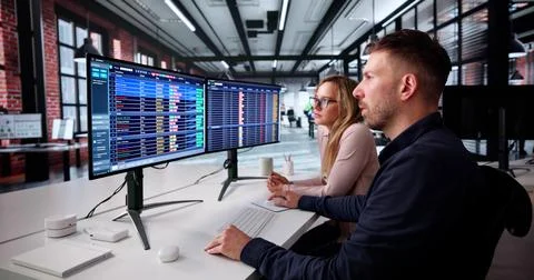Data Analyst Analyzing Spreadsheets On Computer In Medical Office Setting. 写真素材