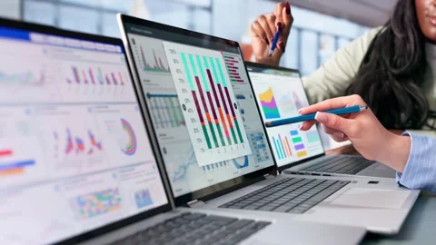 Data Analyst And Financial Consultant Reviewing Market Dashboard Insights Stock Footage 345323831