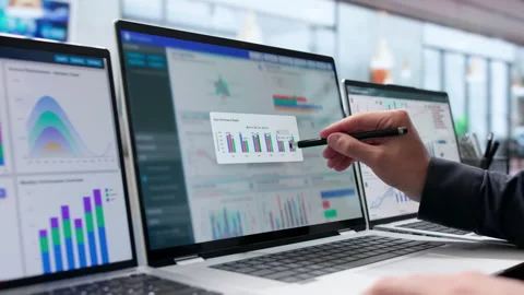 Data Analyst Carefully Monitors Financial KPIs On Laptop Stock Footage 340996278