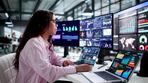 Data Analyst Carefully Monitors Financial Dashboard Stock Footage 346329313