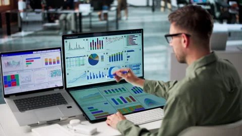 Data Analyst Carefully Reviewing Financial Dashboard Stock Footage 340996843