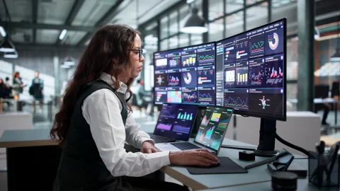 Data Analyst Carefully Reviews Financial Dashboard 動画素材 345862415