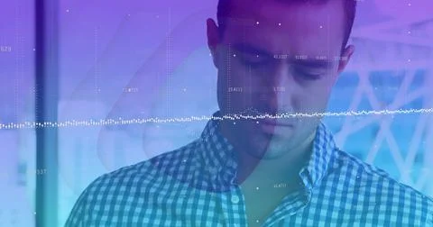 Data analyst in checkered shirt interpreting waveform overlay in tech lab, with Stock Photos