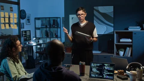 Data Analyst Holding Tablet Presenting Ideas to Two Diverse Young Web Developers Stock Footage 329614907