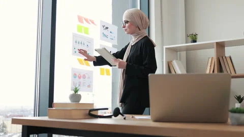 Data analyst matching data from smart device with report Stock Footage 249621333