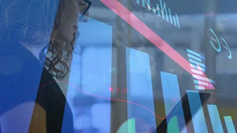 Data analyst raising tablet, checking falling finance chart overlaid with red Stock Footage 333510454